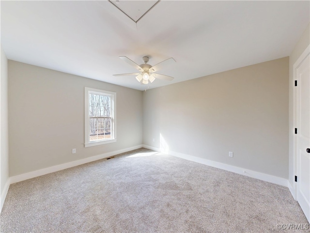 unfurnished room featuring visible vents, baseboards, carpet, and attic access