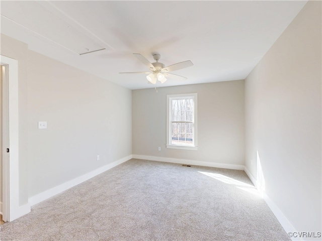 spare room featuring carpet flooring, baseboards, and a ceiling fan