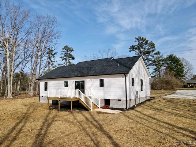 rear view of house featuring crawl space, a yard, roof with shingles, and a wooden deck