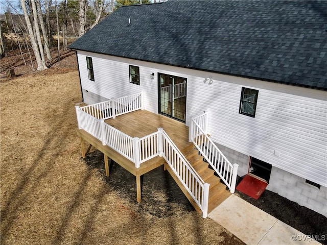 rear view of property featuring a wooden deck, roof with shingles, and crawl space