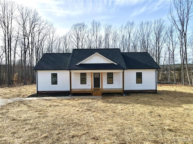 view of front of house with a porch and roof with shingles