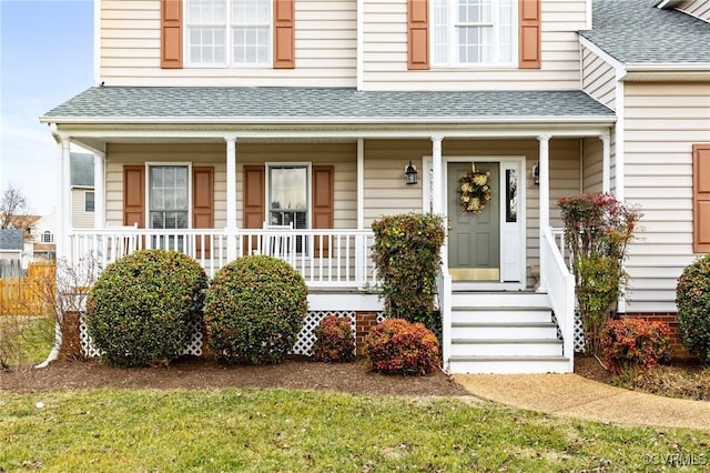 view of front of home with a porch and roof with shingles