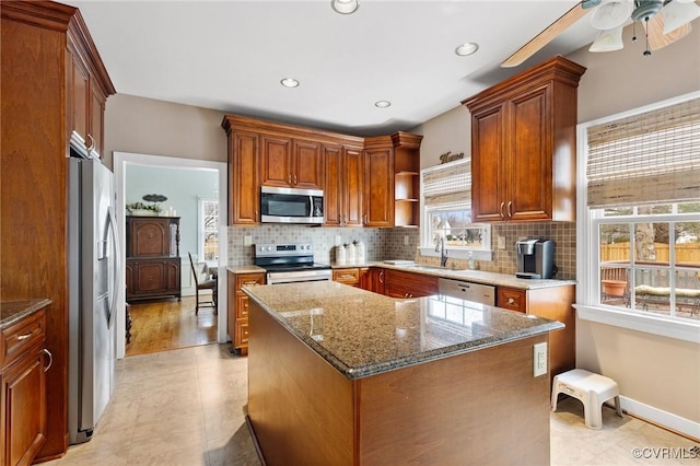 kitchen featuring open shelves, backsplash, appliances with stainless steel finishes, and a sink