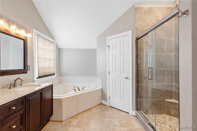 bathroom with vanity, lofted ceiling, a jetted tub, and a stall shower