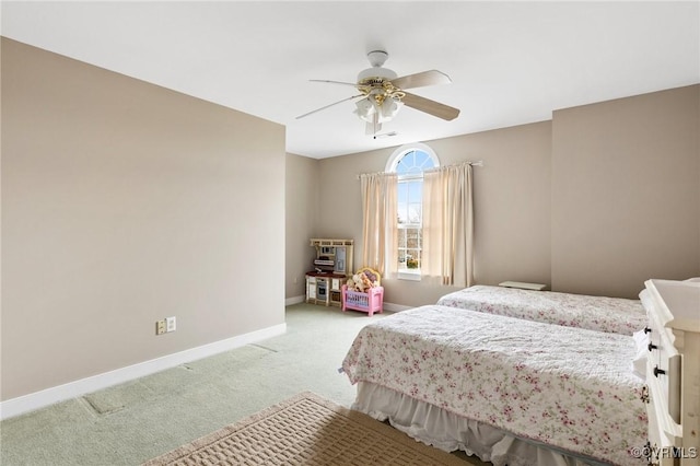 bedroom featuring a ceiling fan, baseboards, and light carpet