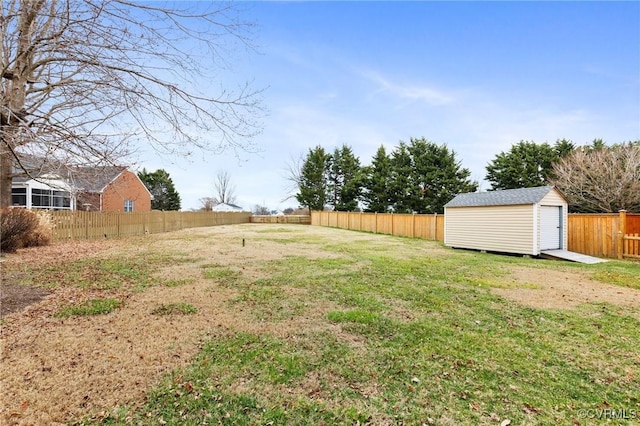 view of yard featuring a fenced backyard, a storage unit, and an outdoor structure