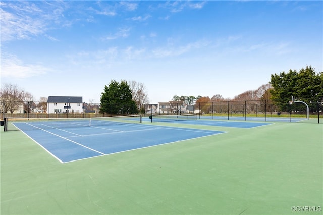 view of tennis court featuring fence