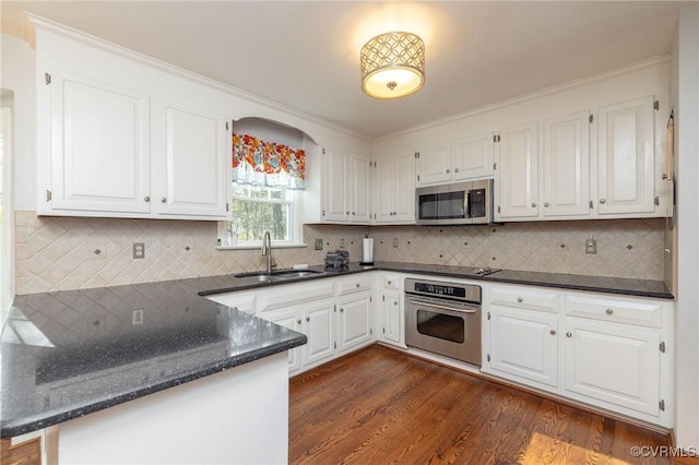 kitchen featuring a sink, white cabinets, and stainless steel appliances