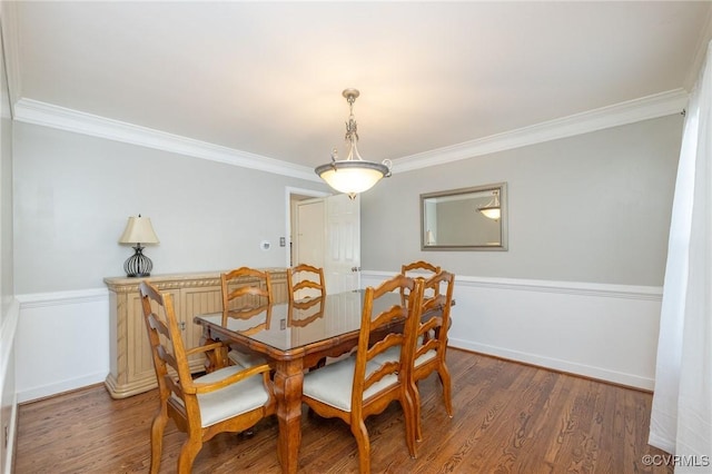 dining area featuring baseboards, wood finished floors, and crown molding