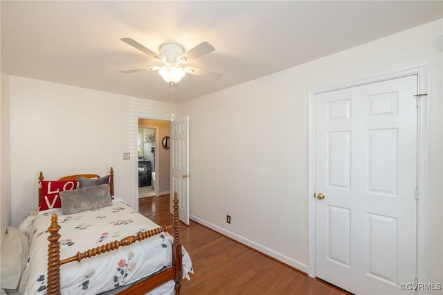 bedroom with baseboards, wood finished floors, and a ceiling fan