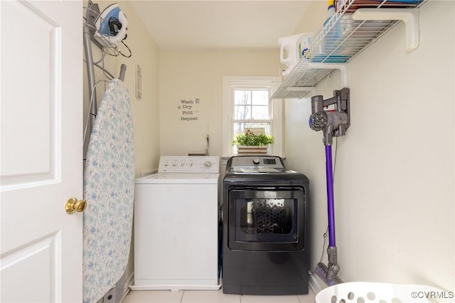 laundry room with tile patterned floors, laundry area, and washing machine and clothes dryer