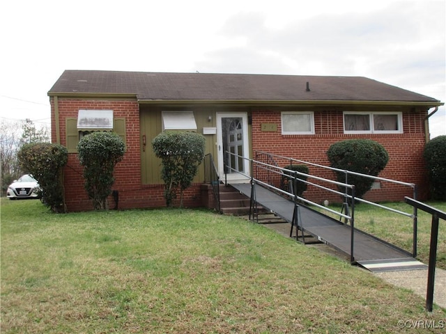 single story home featuring brick siding, entry steps, and a front yard