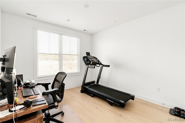 office space featuring visible vents, baseboards, and light wood-style floors