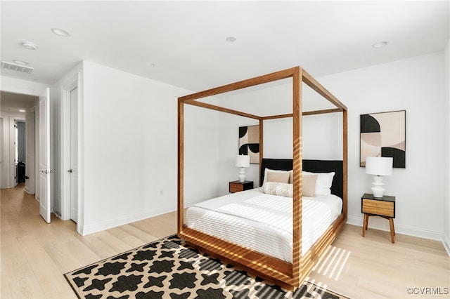 bedroom with light wood-type flooring, visible vents, baseboards, and recessed lighting