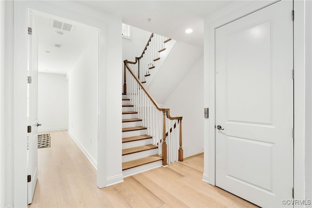 stairs featuring visible vents, recessed lighting, baseboards, and wood finished floors