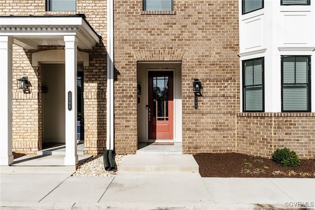 view of exterior entry with brick siding