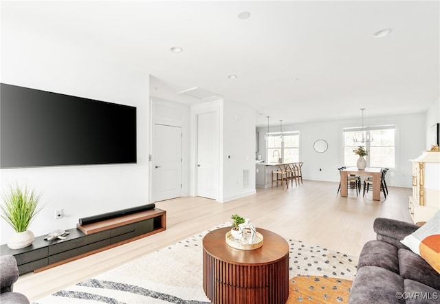 living room with recessed lighting and light wood finished floors