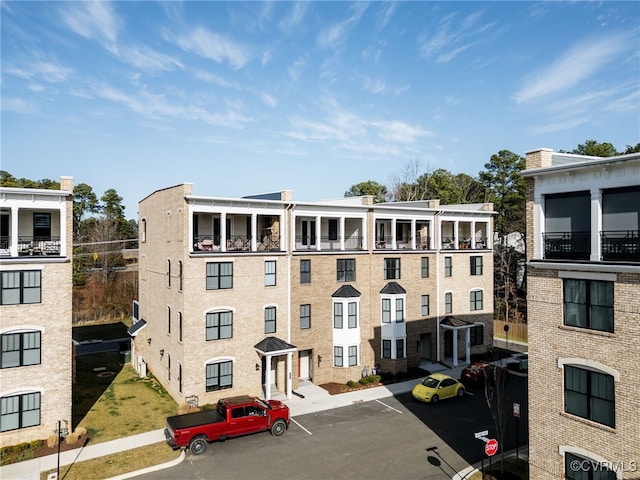 view of property featuring uncovered parking