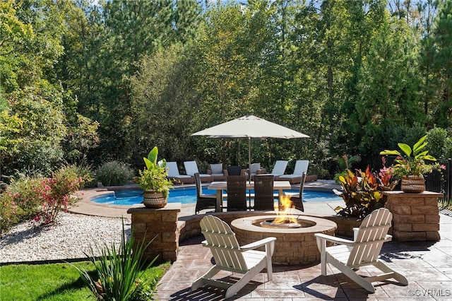 pool featuring a patio area and a fire pit