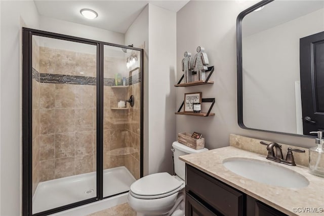 full bath featuring a stall shower, toilet, and vanity