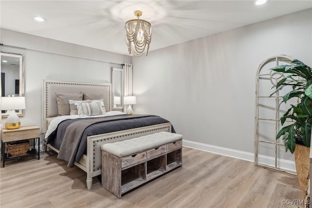 bedroom with a notable chandelier, recessed lighting, baseboards, and wood finished floors