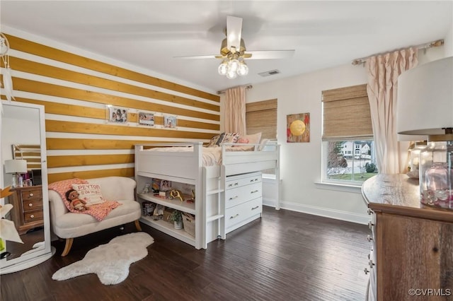 bedroom featuring visible vents, a ceiling fan, dark wood-type flooring, and baseboards