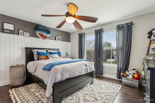 bedroom featuring dark wood finished floors, baseboards, and ceiling fan