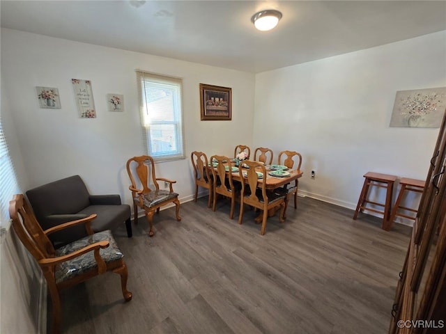 dining space with baseboards and dark wood-style floors