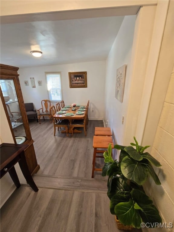 dining area with wood finished floors