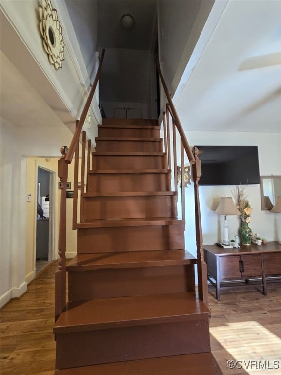 stairway featuring wood finished floors