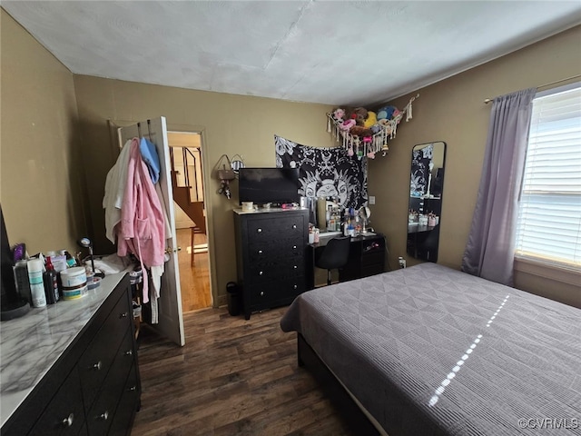 bedroom featuring dark wood-style floors