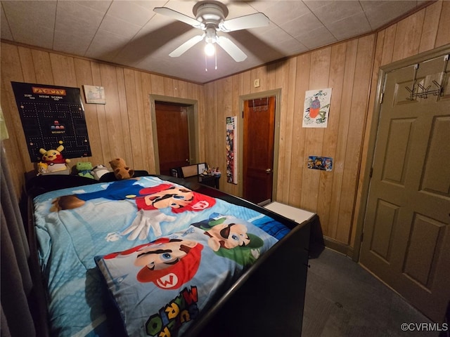 bedroom featuring wood walls and a ceiling fan