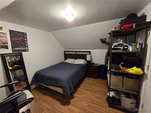 bedroom featuring vaulted ceiling and wood finished floors