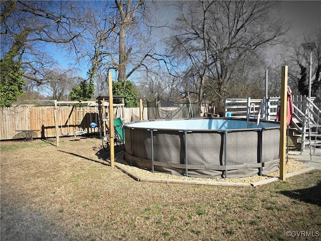 view of pool featuring a fenced in pool, a lawn, and a fenced backyard