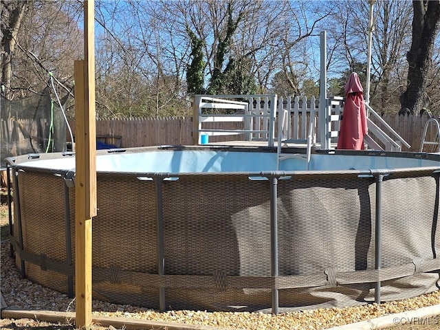 view of pool featuring a fenced in pool, a playground, and fence