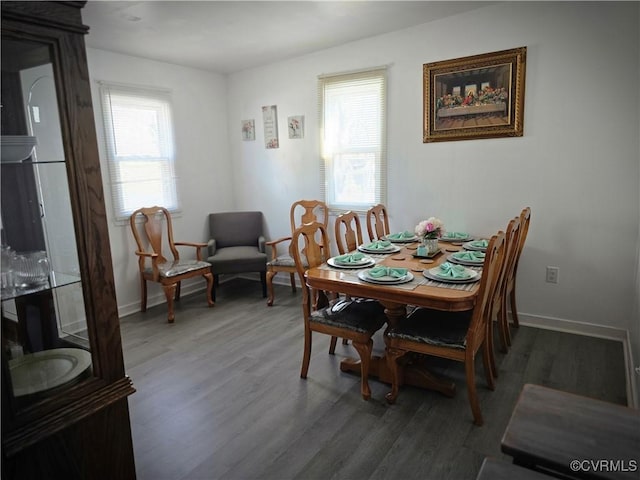 dining area featuring wood finished floors and baseboards