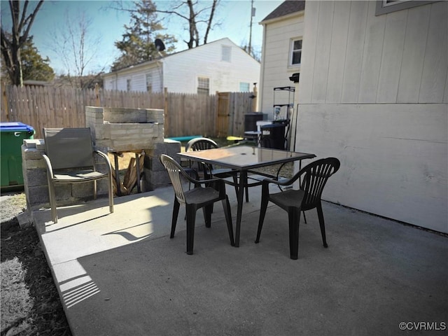 view of patio with outdoor dining space and fence