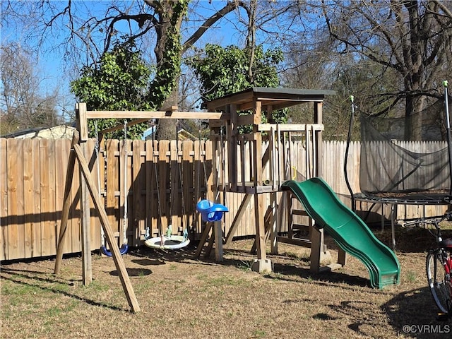 view of jungle gym featuring fence