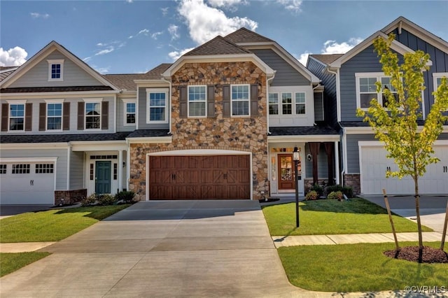 view of front facade with board and batten siding, concrete driveway, a front yard, stone siding, and an attached garage