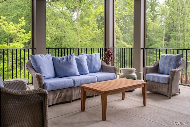 sunroom / solarium with a healthy amount of sunlight and a view of trees