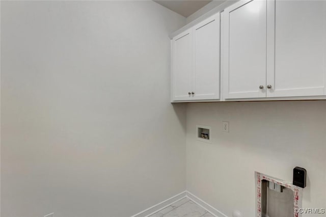 clothes washing area with cabinet space, hookup for a washing machine, marble finish floor, and baseboards