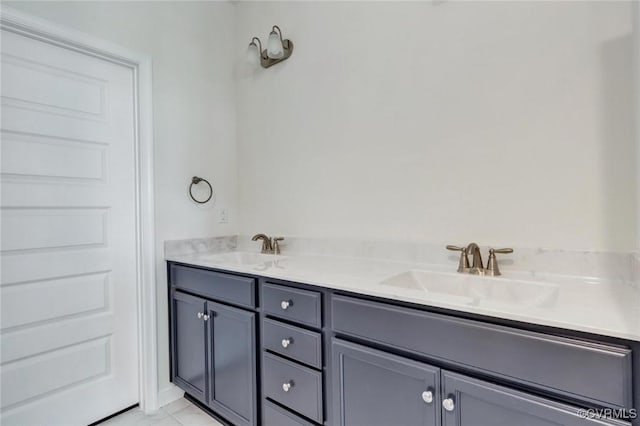 full bath featuring a sink, marble finish floor, and double vanity