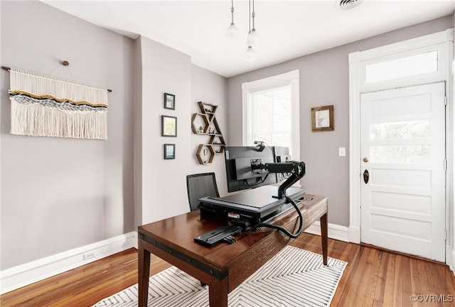 office featuring baseboards and light wood-style flooring