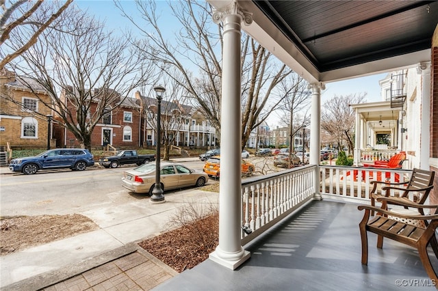 balcony featuring a porch and a residential view