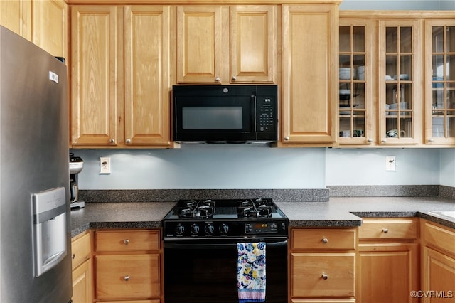 kitchen with dark countertops, black appliances, and glass insert cabinets