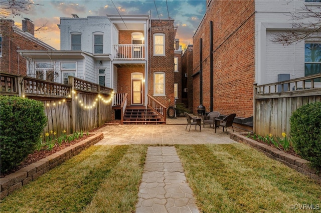 back of house featuring a yard, brick siding, and fence private yard