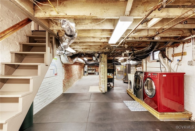 unfinished basement featuring washing machine and dryer and brick wall