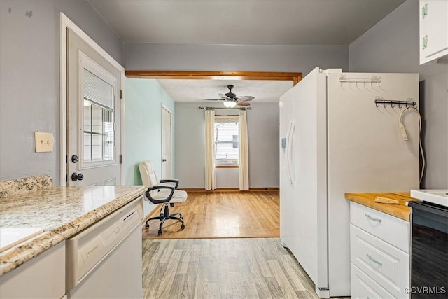 kitchen with white appliances, a ceiling fan, baseboards, white cabinetry, and light wood-type flooring