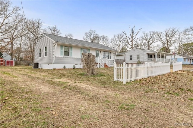 view of front of property featuring a front lawn, fence private yard, central AC unit, an outdoor structure, and crawl space