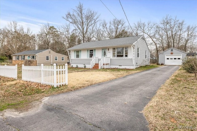 view of front facade with an outdoor structure, a garage, a fenced front yard, crawl space, and aphalt driveway